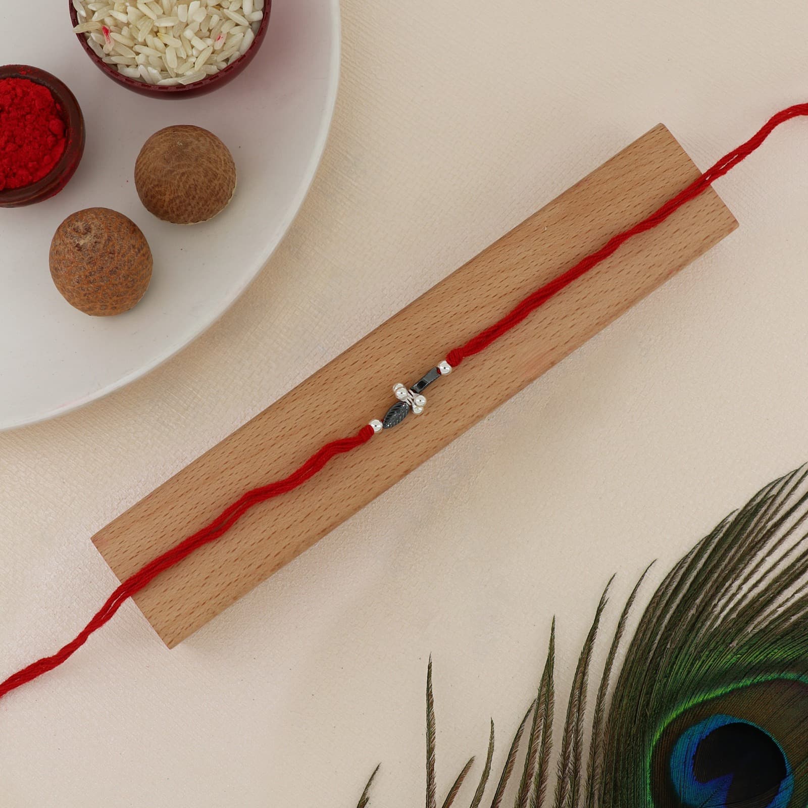 Silver Leaf Charm Rakhi | Elegant Leaf Motif with Hematite & Silver Accents | Adjustable Red Thread