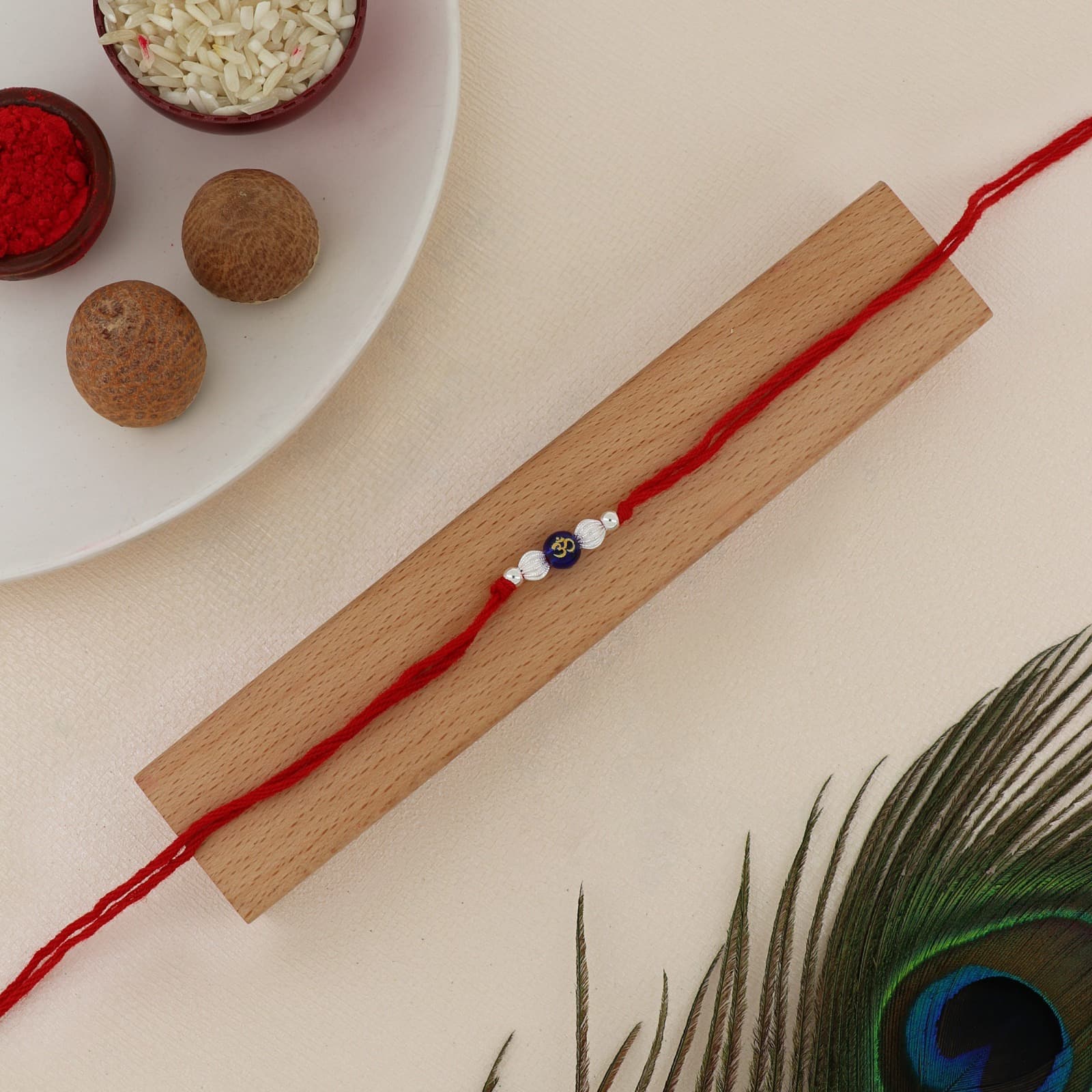 Silver Om Spiritual Rakhi | Blue Om Bead Rakhi with Textured Silver Beads | Adjustable Red Thread